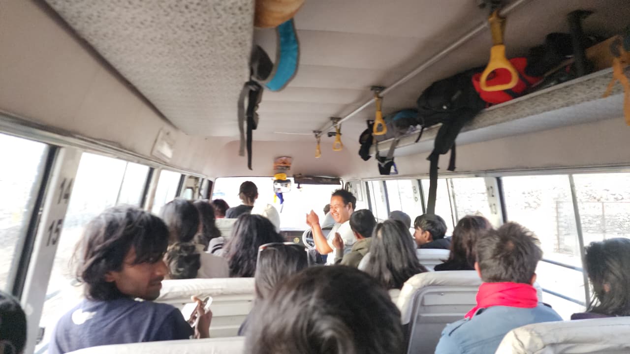 Group of solo travellers chatting inside the trip bus