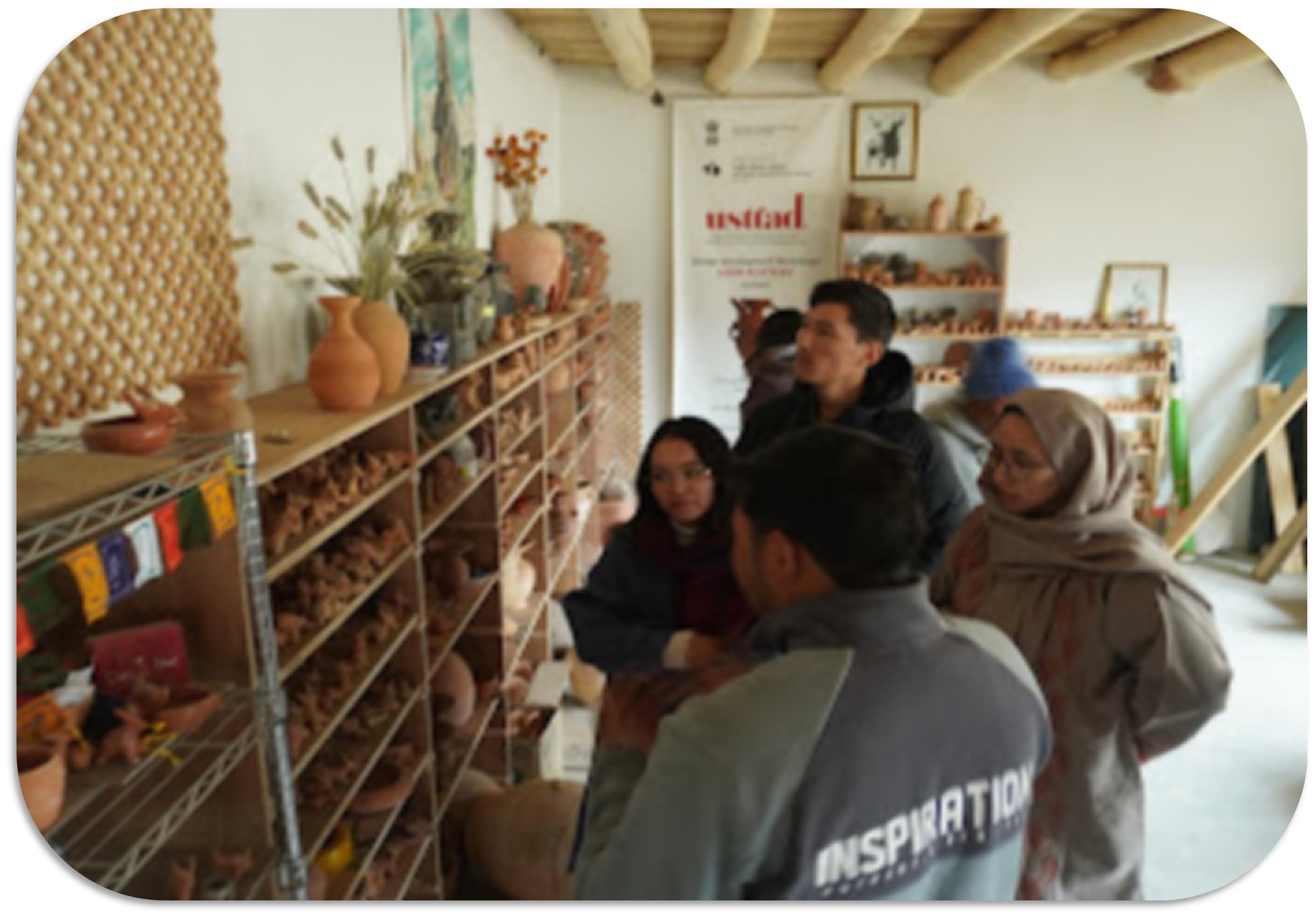 Visitors inside a pottery workshop in Ladakh